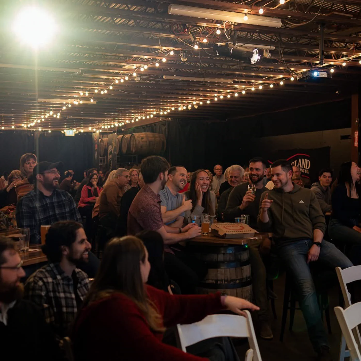 A full room laughing during a Wade Live comedy magic show