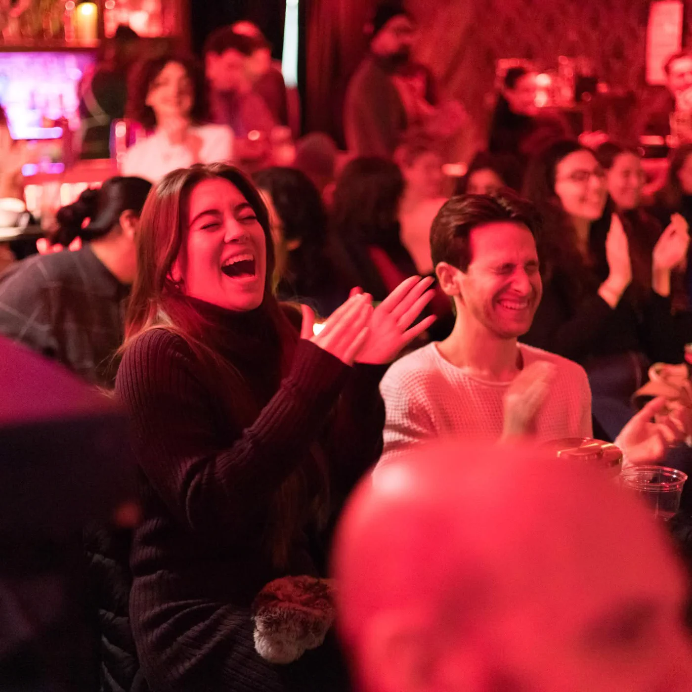 Guests laughing and applauding during a Wade Live show