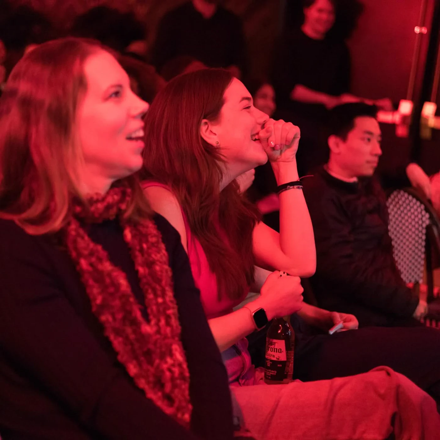 Guests laughing in the front row of a Wade Live show