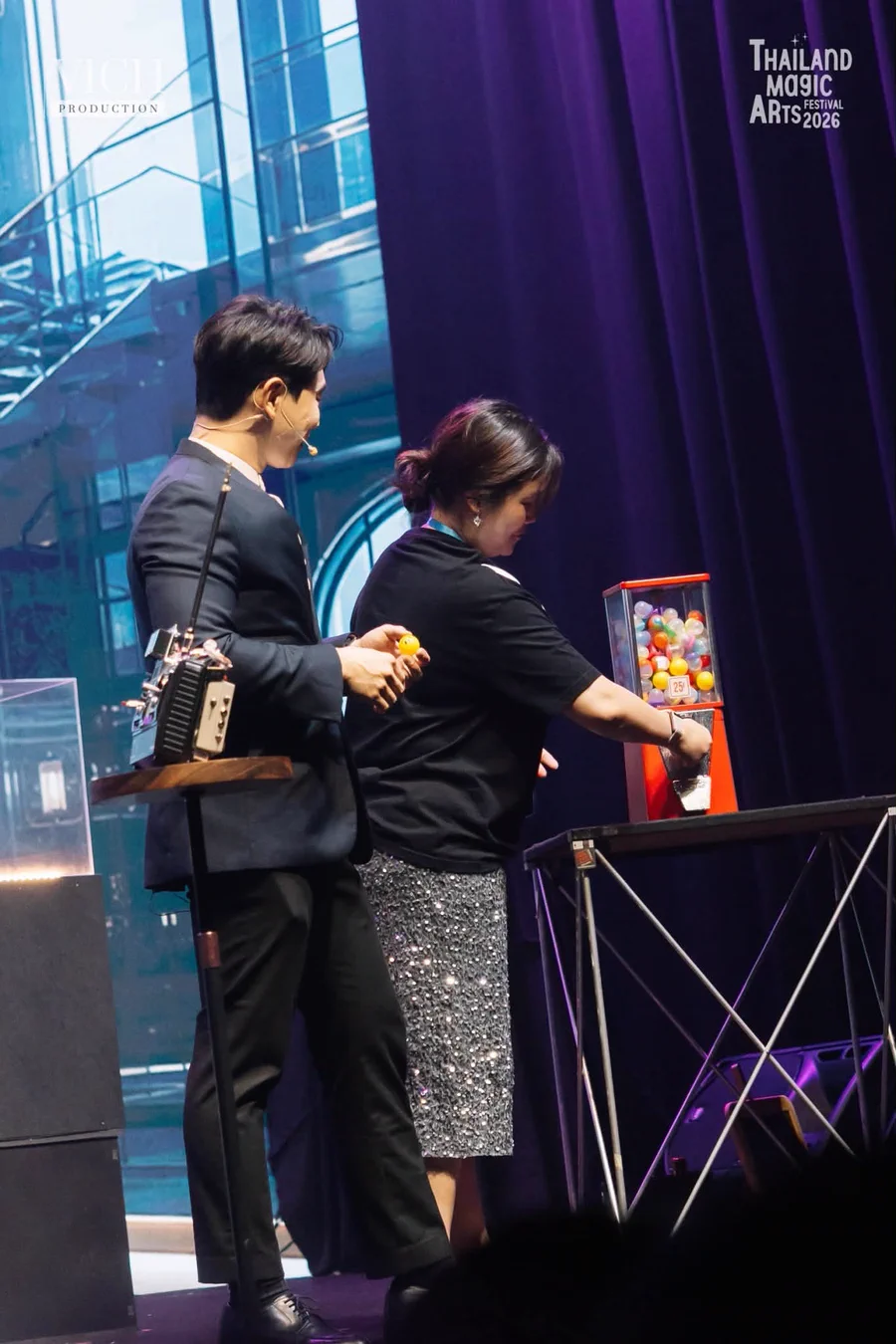 Patrick Kun and a spectator beside The Machine on the Thailand Magic Arts Festival stage