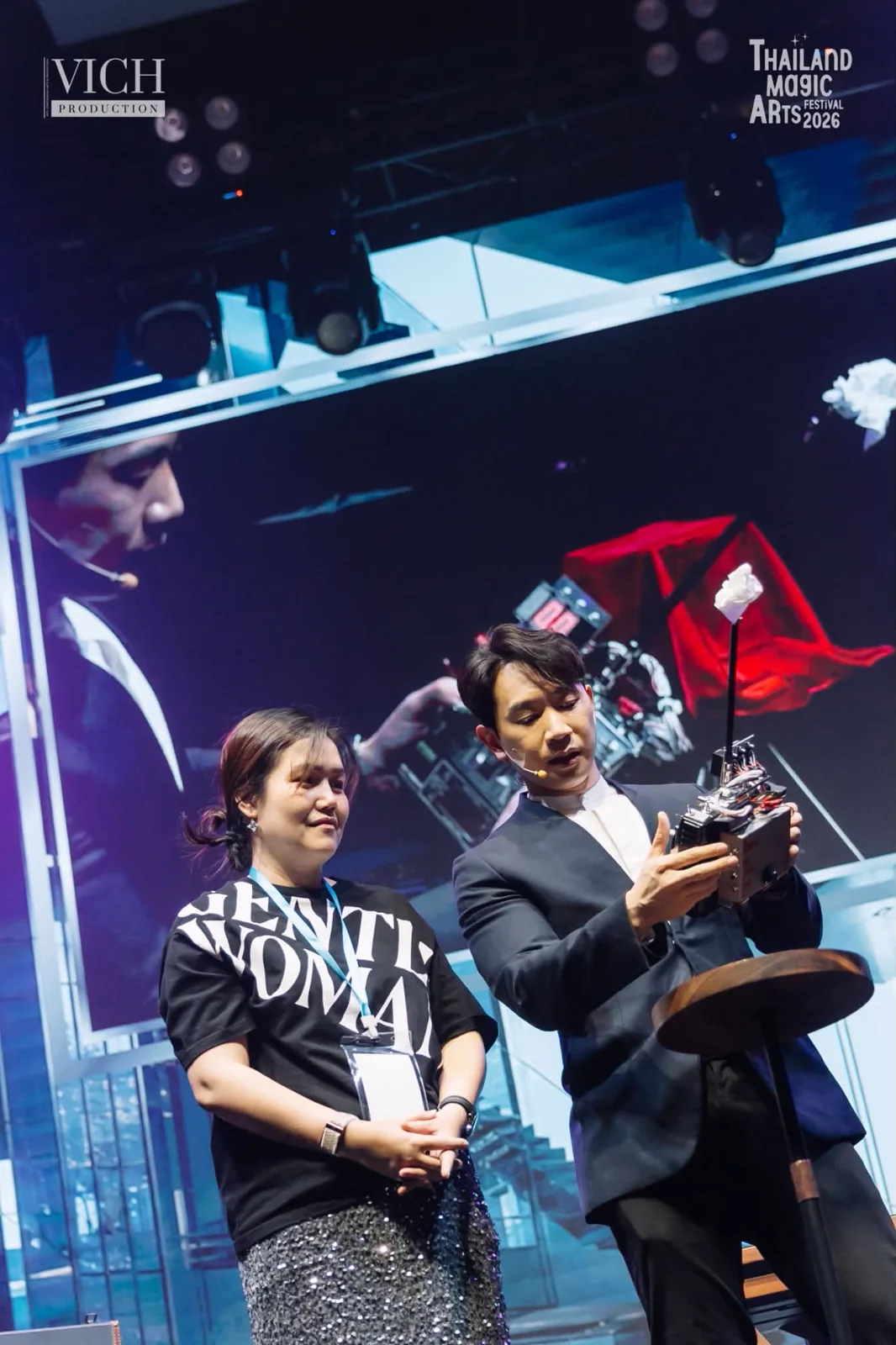 Patrick Kun showing The Remote to a spectator on stage during Magic Dreams