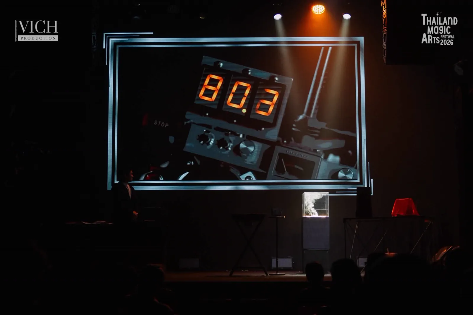 The Remote shown in close up on the large stage screen during Patrick Kun's Magic Dreams