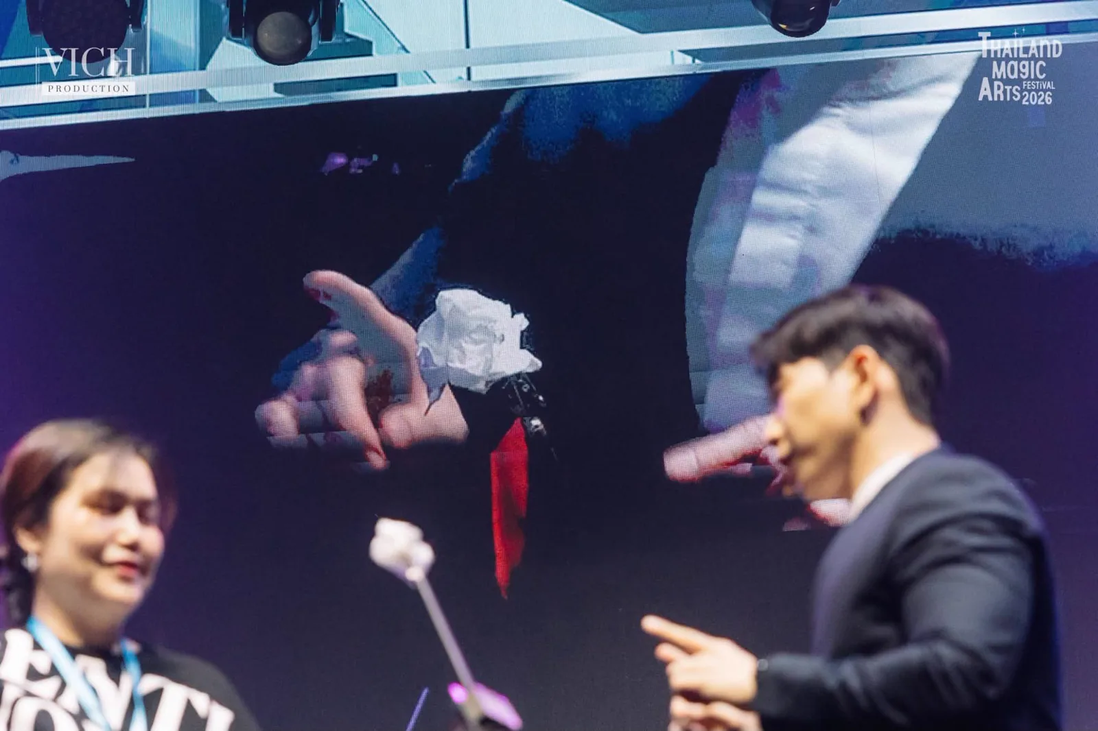 A close up of a hand on the large stage screen during Patrick Kun's Magic Dreams