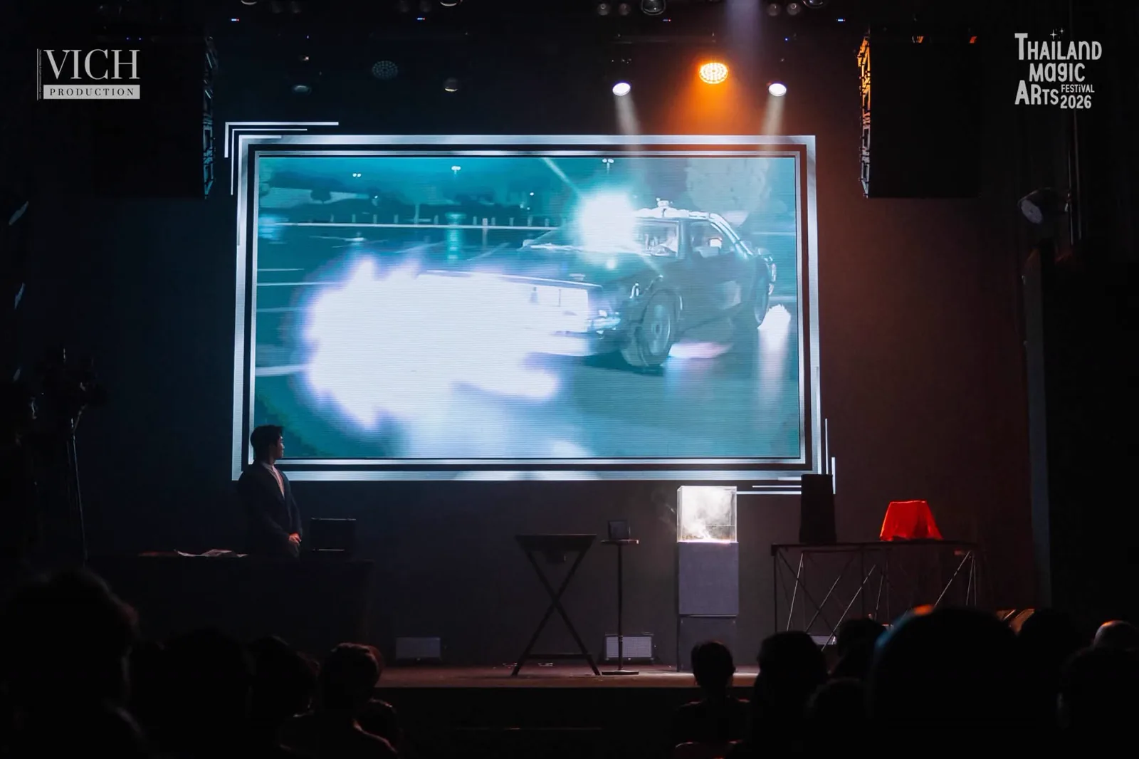 A cinematic scene on the large stage screen during Patrick Kun's Magic Dreams